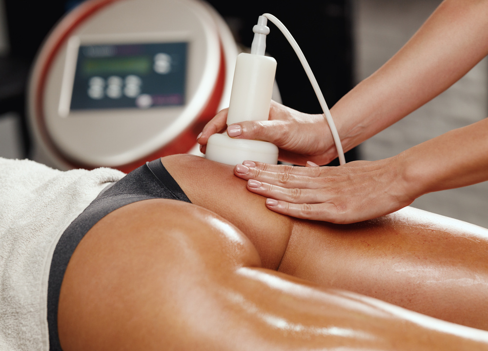 Shot of an unrecognizable woman getting anti cellulite massage at the beauty salon. She have an ultrasound cavitacion treatment to fat reduction.